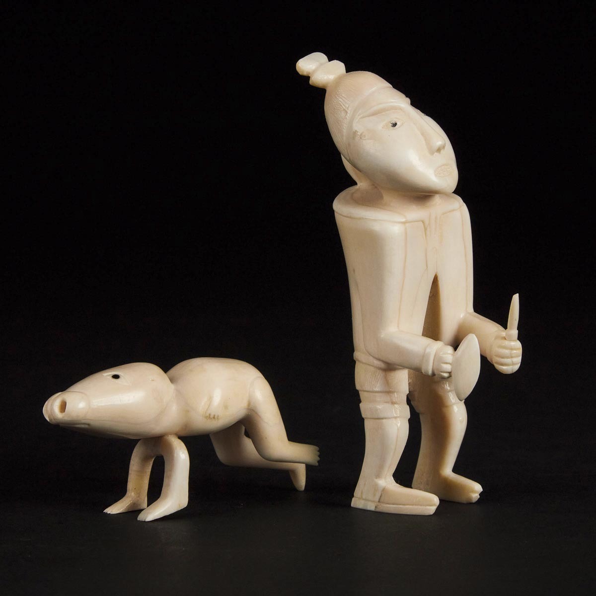 Unidentified Artist, PAIR OF TUPILAQS, ivory, largest 4.75 x 2 x 1.5 in — 12.1 x 5.1 x 3.8 cm - Image 2 of 3