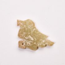 An Archaic Celadon and Russet Jade 'Bird' Pendant, Shang Dynasty (1600-1100 BC), 商 玉凤鸟形佩, 1 x 1.3 in