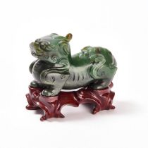 A Spinach Jade Figure of a Mythical Beast, 19th Century, 清 十九世纪 碧玉雕瑞兽, length 4.5 in — 11.5 cm