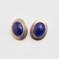 Pair Of Carol Felley Sterling Silver Button Earrings, each bezel set with an oval lapis cabochon