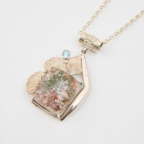 Sterling Silver Pendant, set with a 'garden' quartz panel and a small full cut blue topaz, suspended