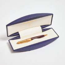 Waterman Edsol 'Ruby Red' Roller ball Pen, translucent red resin barrel and gold plated top; in the