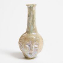 Roman Pale Turquoise Mould-Blown Glass Medusa Head Flask, late 1st-early 2nd century A.D., height 3.