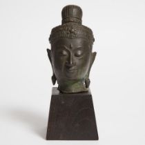 South East Asian Bronze Head of Buddha, 19th century or earlier, bronze height 7 in — 17.8 cm; on eb