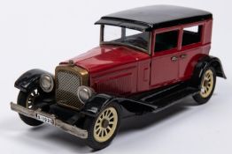 A Japanese Tinplate 1930s American style Sedan. In red with black roof, sun visor, mudguards and