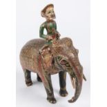 A 19th Century carved wood figure of an elephant with mahout, colourfully decorated with paint and