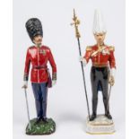 2 porcelain figurines: Gentleman at Arms, with partizan, 12¼"; and Scots Guards Captain with metal