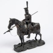 A bronzed composition equestrian figure of a French Napoleonic period mounted lancer, with lowered
