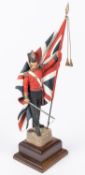 A good Charles Stadden figurine of an infantry officer c 1854 with Regimental Colours, height 13",