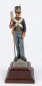 A good Charles Stadden figurine of a Waterloo Period Gunner, with polished wood base, height 12";