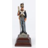 A good Charles Stadden figurine of a Waterloo Period Gunner, with polished wood base, height 12";