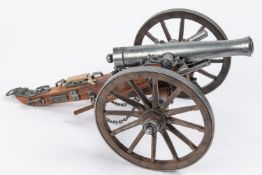 A model of a Waterloo period field gun, barrel 7½", on its 2 wheeled wooden carriage with rammer,