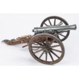 A model of a Waterloo period field gun, barrel 7½", on its 2 wheeled wooden carriage with rammer,