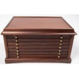 A mahogany collectors cabinet, with five shallow drawers, each to house 20 medallions, and a