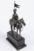 A bronzed composition equestrian figure of a mounted lancer, with lance cap, sword and lance, on