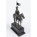 A bronzed composition equestrian figure of a mounted lancer, with lance cap, sword and lance, on