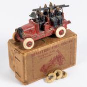 A Johillco Miniature Fire Engine. A red painted fire engine with bell, ladder and complete with 6