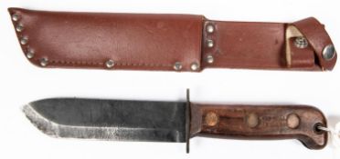 A military sheath knife, blade 7", wood hilt stamped 1988 etc, in its brown leather sheath. GC £20-