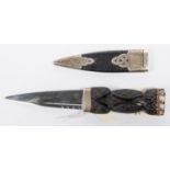 A good quality skean dhu sock knife, blade 3½", carved wood handle with stone pommel, silver mounted