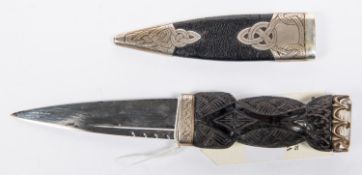 A good quality skean dhu sock knife, blade 3½", carved wood handle with stone pommel, silver mounted