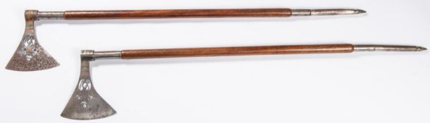 A pair of Indian battle axes, length 38", fretted and copper inlaid steel heads, brass wire inlaid