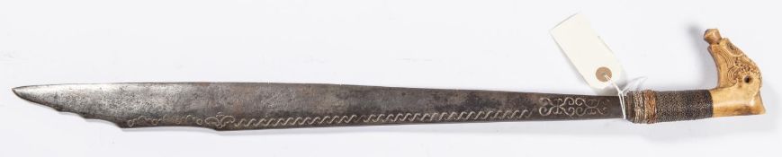 A Malayan sword kleewang, blade 20½”, nicely carved bone hilt with rattan binding. GC £80-100