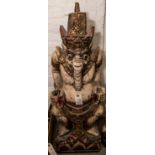 A large carved wood Malay kris stand, height 33", depicting a colourfully painted pot bellied