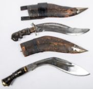 A Gurkha kukri, blade 11", in its sheath; another similar kukri type knife 10½" in its sheath. GC (