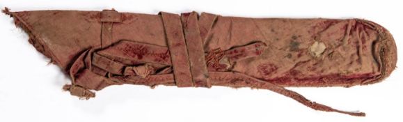 An 18th century Indian quiver, 26" overall, of thin hide covered with fabric and red velvet, the red
