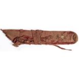 An 18th century Indian quiver, 26" overall, of thin hide covered with fabric and red velvet, the red