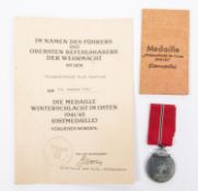 A Third Reich Eastern Front medal in its original envelope together with certificate named to "