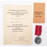 A Third Reich Eastern Front medal in its original envelope together with certificate named to "