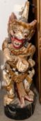 A carved wood Malay kris stand, height 24", depicting a colourfully painted grotesque deity. GC £