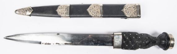 A Scottish Piper’s dirk, blade 11½", black wood hilt with inlaid pique studs, WM pommel with KC.