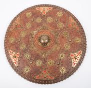 A modern replica of a Scottish targe, 20" diameter, embossed leather covered wood with brass central
