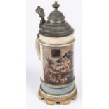 A German ½ litre musical beerstein, decorated with a scene of men and women in Tyrolean dress seated