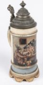 A German ½ litre musical beerstein, decorated with a scene of men and women in Tyrolean dress seated
