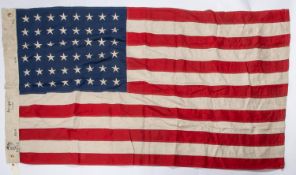 A good quality 48 star US flag, 60" x 34", of stitched construction, edge stamped "USMC 1944" etc.