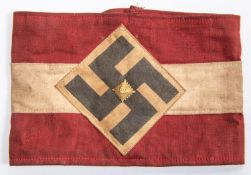 A Third Reich Hitler Youth red and white armband, with applied swastika motif and gilt central