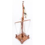 An Imperial German nautical desk ornament in the form of a partly rigged mast flying naval ensign,