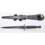 A Third pattern FS fighting knife, blued blade 6¾", ribbed blackened hilt, in its leather sheath.