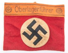 A Third Reich Party armband, red cloth with applied swastika panel and attached "Oberlagerfuhrer"