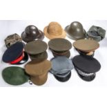 2 WWII steel helmets, RAF cap, Queen's Regt cap, Sussex Police cap, green beret, 2 Russian caps, 3