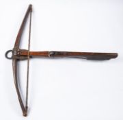 A 17th century European crossbow, length 30", with dark walnut stock, the butt branded with initials