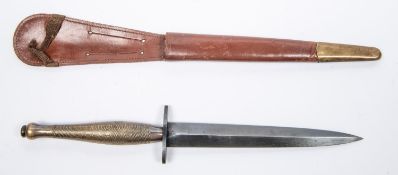 A WWII 2nd pattern FS knife, chequered bronze grip, blued blade 6½", in its brass mounted brown