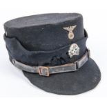 An early type Third Reich kepi, black cloth with metal eagle and skull, lining marked with maker's