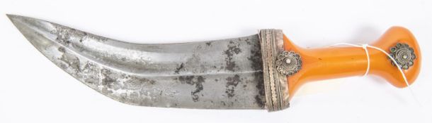 An Arab jambiya, blade 7¾” with central rib, amber handle with WM mounts. GC £50-80