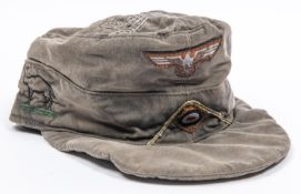 A Third Reich Tropical service peaked field cap, embellished with Afrika Korps designs inside and