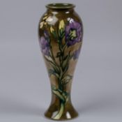 A Moorcroft pottery slim vase. Bees with flowers on graded green ground. Marks to base, leaf date