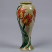 A Moorcroft pottery slim vase. Parrot tulips on a green ground. Impressed marks to base, GP,